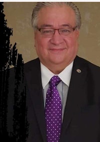 a man in a suit and tie is smiling